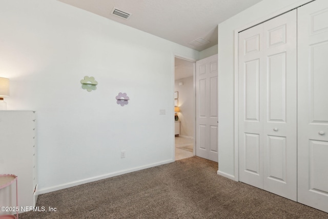 unfurnished bedroom with carpet and a closet