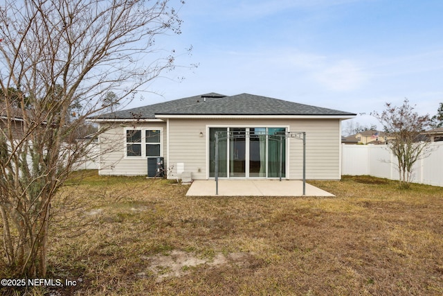 back of property featuring central air condition unit, a yard, and a patio