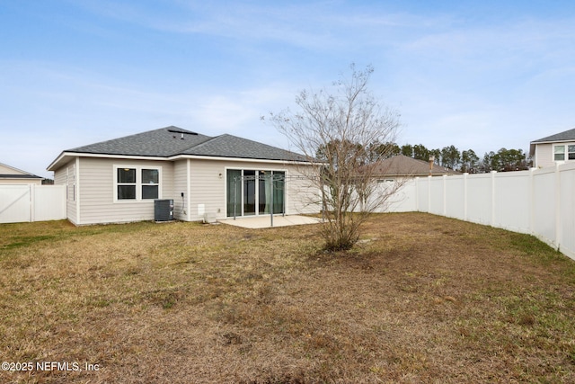 back of house with a lawn, a patio, and central AC