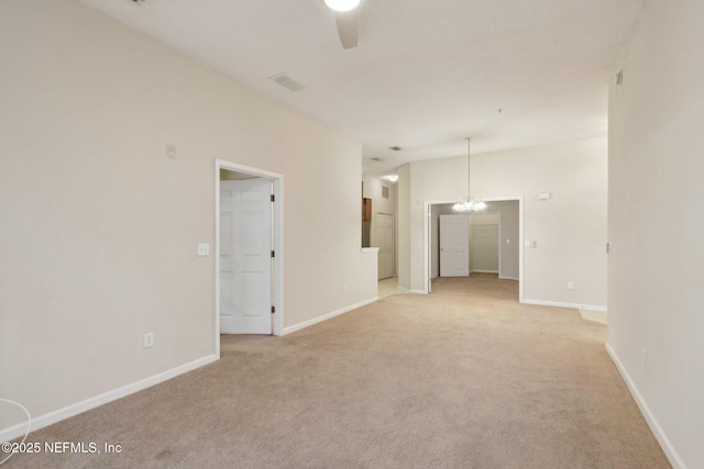 spare room with light colored carpet, visible vents, baseboards, and ceiling fan with notable chandelier