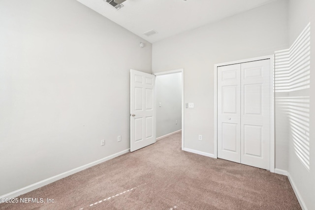 unfurnished bedroom featuring a closet, carpet flooring, visible vents, and baseboards