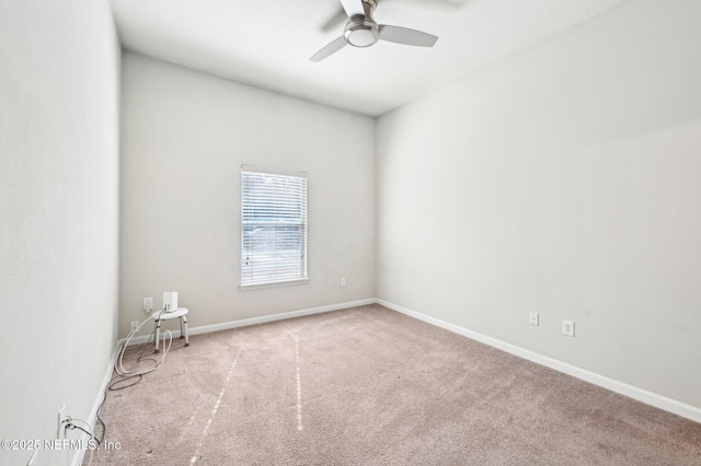 empty room with ceiling fan, carpet flooring, and baseboards