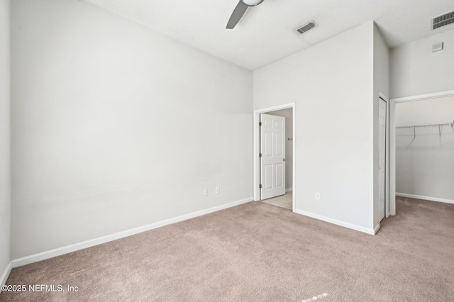 unfurnished bedroom with carpet flooring, visible vents, and baseboards