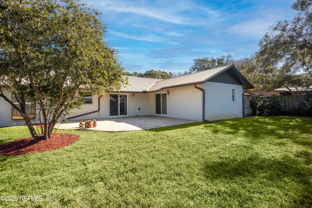 back of property featuring a patio area and a yard