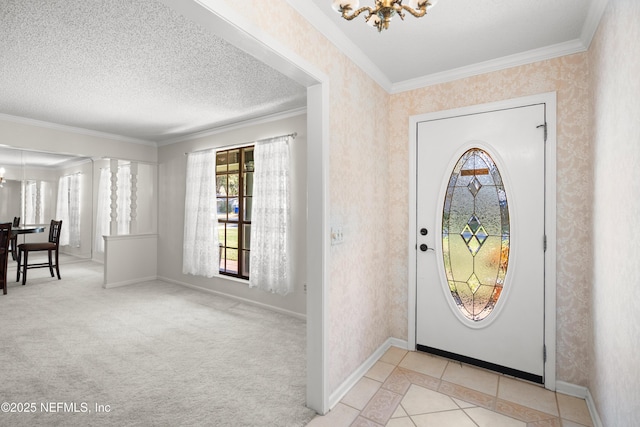 carpeted entryway featuring a notable chandelier, ornamental molding, and a textured ceiling