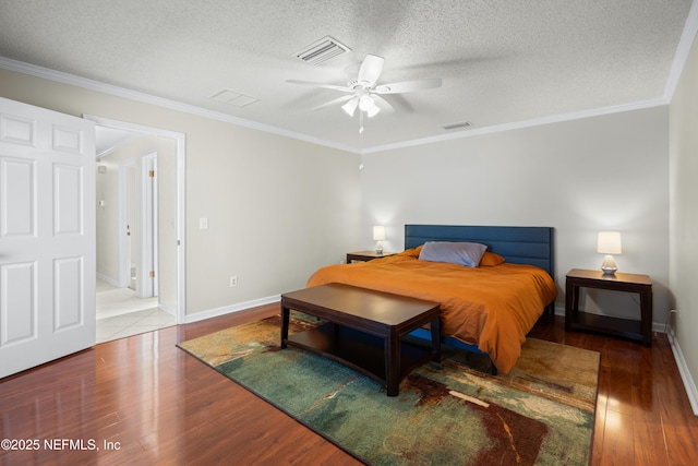 bedroom featuring ceiling fan, crown molding, wood-type flooring, and a textured ceiling