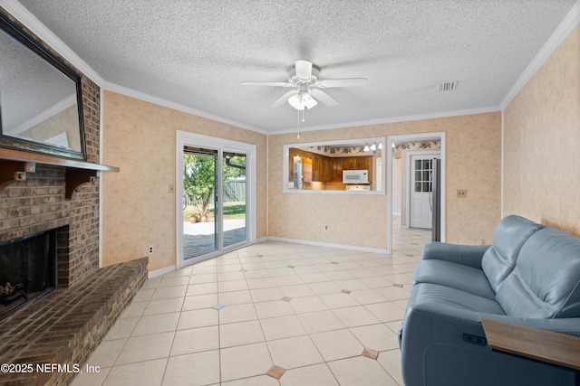 tiled living room with a textured ceiling, a brick fireplace, ceiling fan, and crown molding