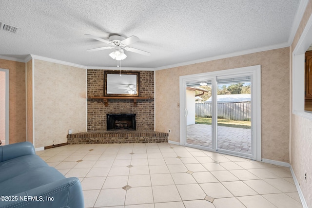 unfurnished living room featuring ceiling fan, ornamental molding, a textured ceiling, a fireplace, and light tile patterned floors