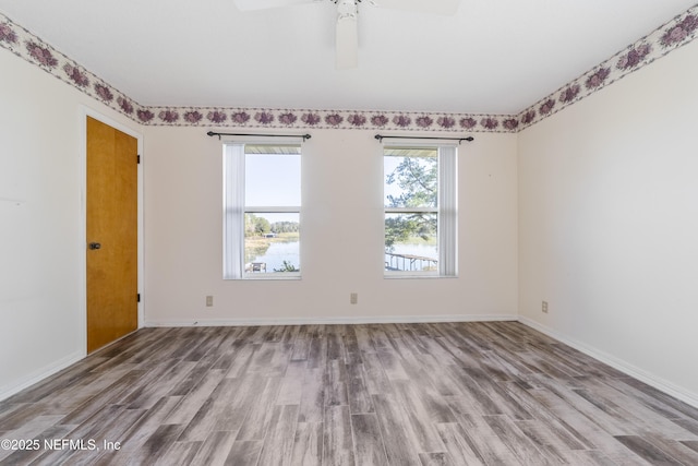 spare room featuring ceiling fan and light hardwood / wood-style flooring