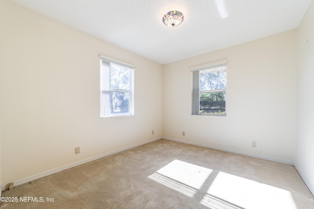 carpeted spare room featuring a textured ceiling