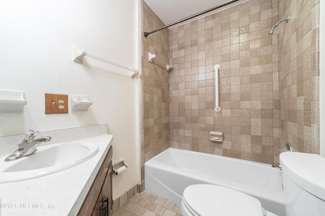 full bathroom with toilet, tiled shower / bath combo, tile patterned flooring, and vanity