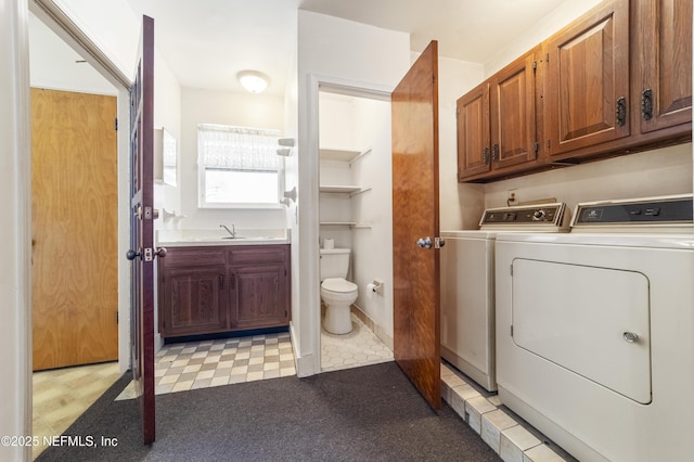 bathroom featuring vanity, washing machine and clothes dryer, and toilet