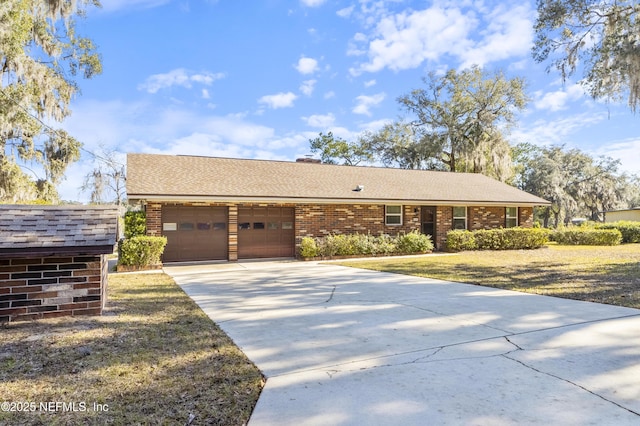 ranch-style home with a front yard and a garage