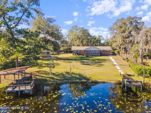 exterior space featuring a yard and a water view