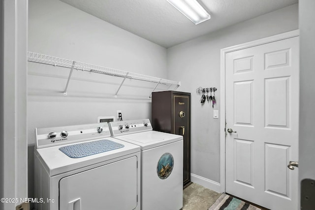 washroom featuring separate washer and dryer and a textured ceiling