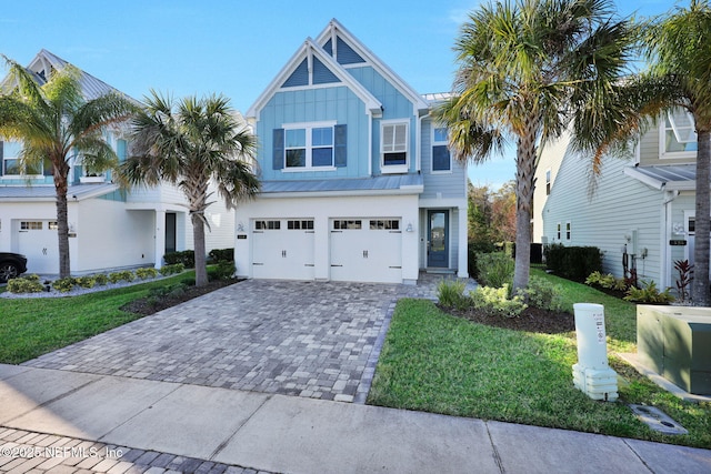 view of front of home with a garage and a front lawn