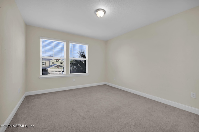 unfurnished room featuring carpet