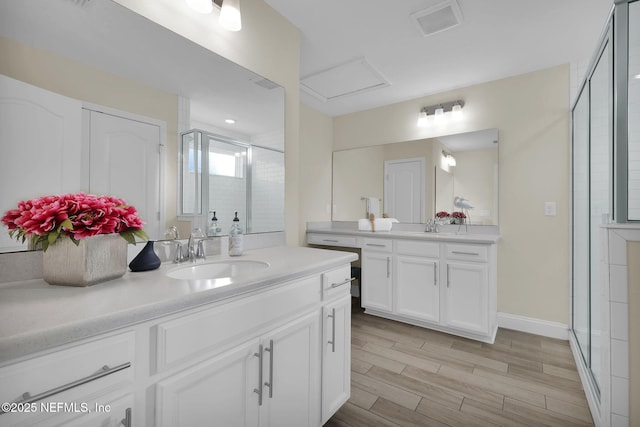 bathroom with vanity and a shower with shower door