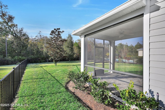 view of yard with ceiling fan and a sunroom