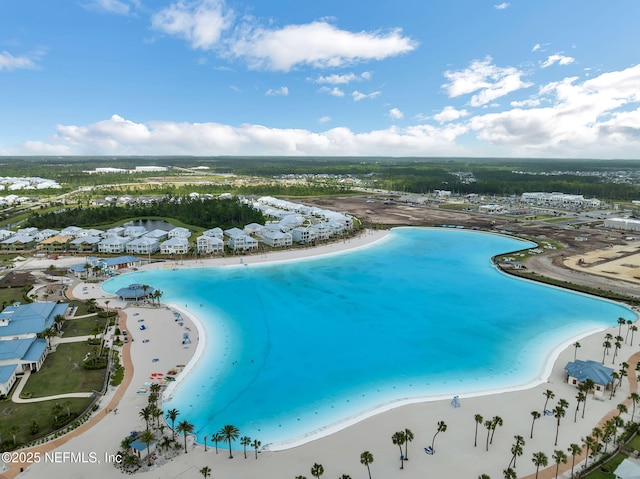 birds eye view of property featuring a water view and a beach view