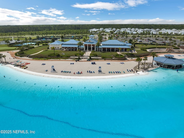 drone / aerial view featuring a beach view and a water view