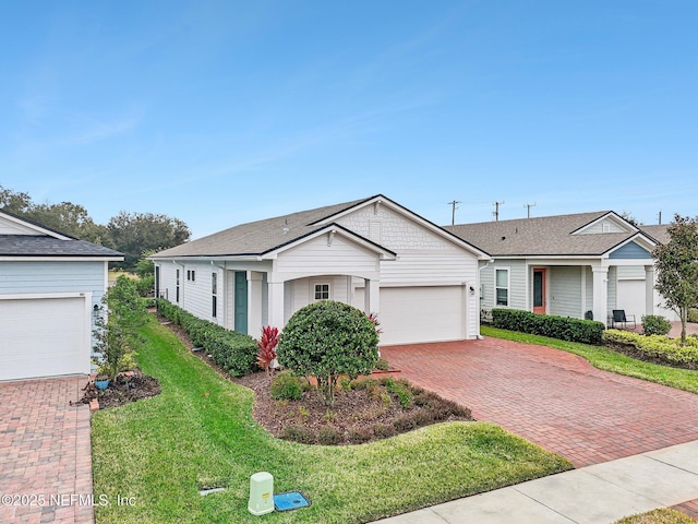 ranch-style house featuring a garage and a front yard