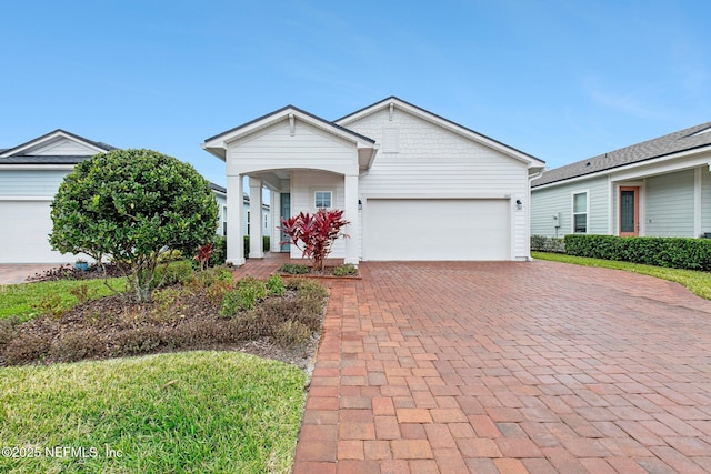 single story home featuring covered porch and a garage