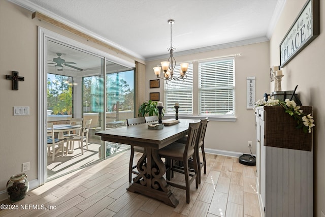 dining space with ceiling fan with notable chandelier and ornamental molding