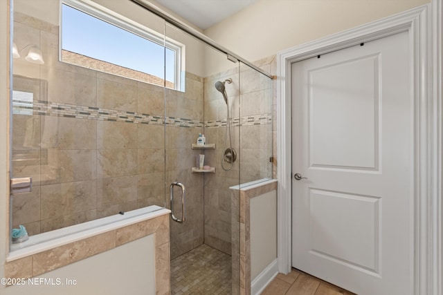 bathroom with hardwood / wood-style flooring and walk in shower