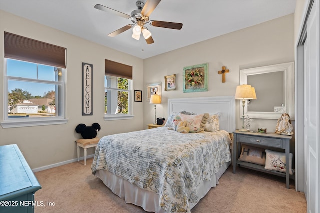 carpeted bedroom featuring ceiling fan and a closet