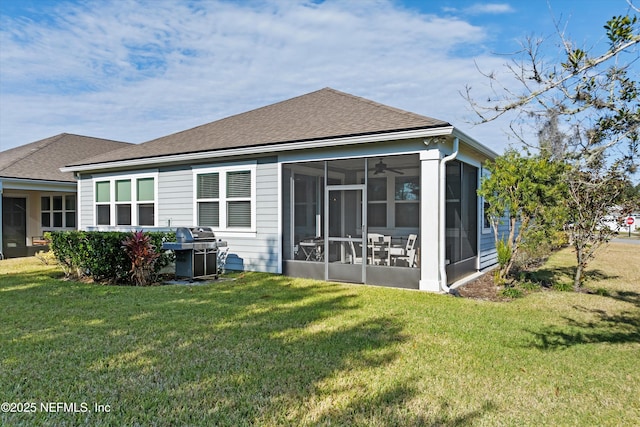 back of property with a sunroom and a lawn