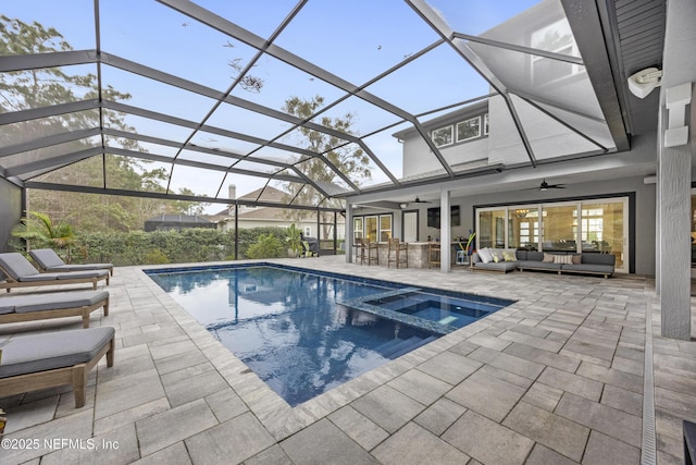 view of swimming pool featuring a patio area, an in ground hot tub, ceiling fan, a lanai, and an outdoor living space