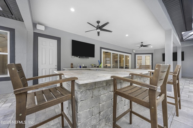 view of patio featuring ceiling fan