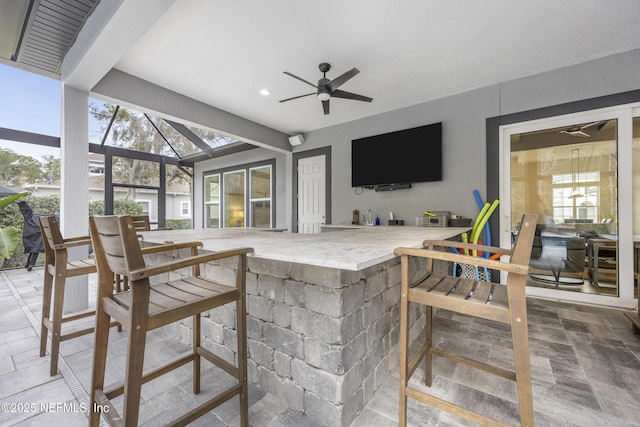 view of patio with glass enclosure and ceiling fan