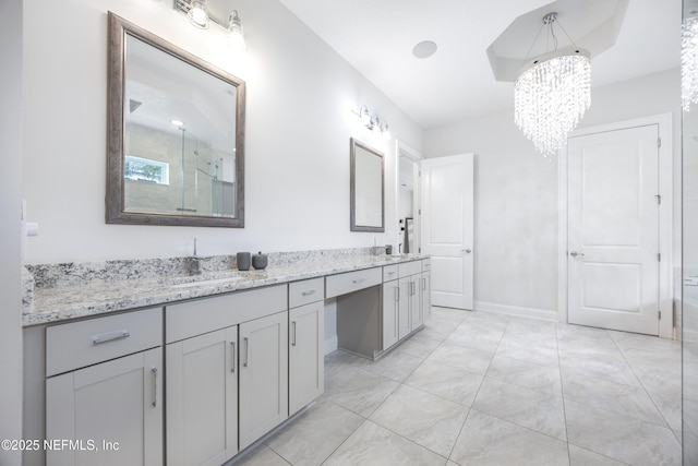 bathroom with vanity, a shower with shower door, and an inviting chandelier