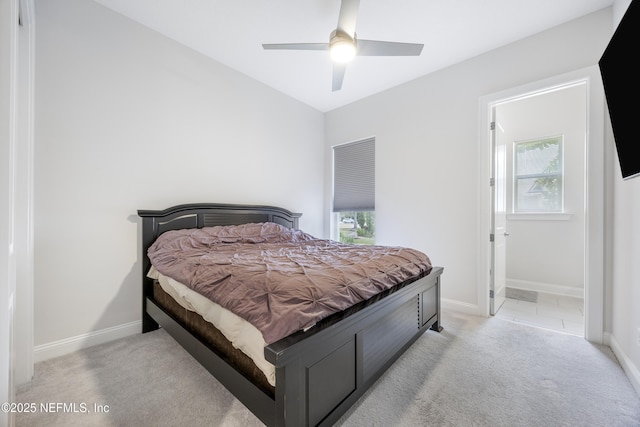 carpeted bedroom with ceiling fan and connected bathroom