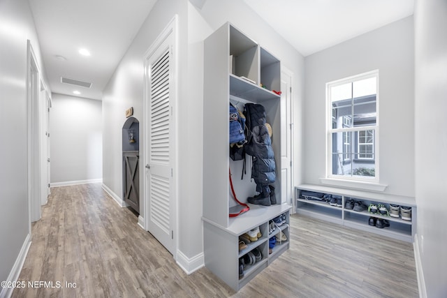 mudroom with light hardwood / wood-style floors