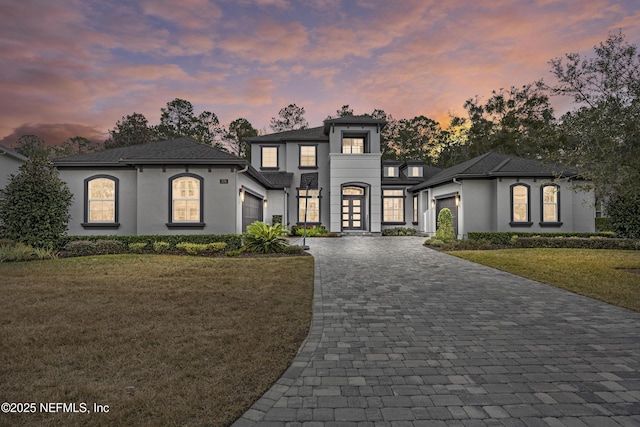 view of front facade with a lawn and a garage