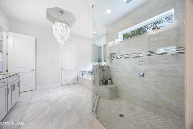 bathroom with vanity, a chandelier, and shower with separate bathtub