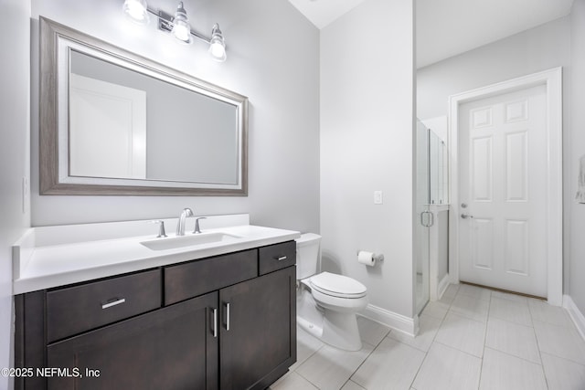 bathroom with vanity, toilet, and an enclosed shower