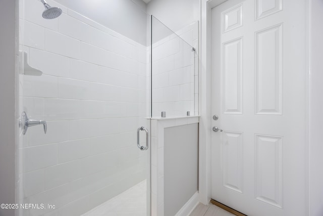 bathroom with a shower with door