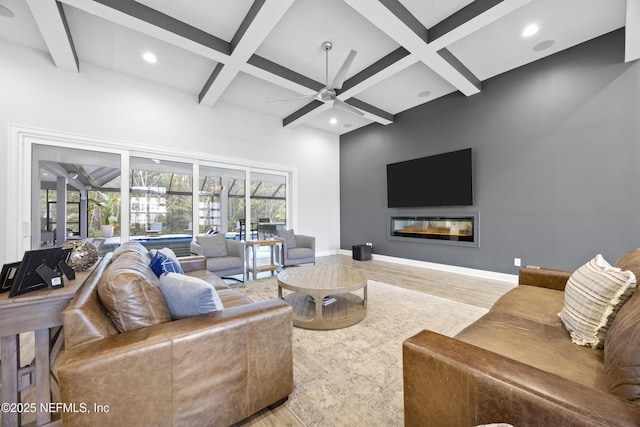 living room with coffered ceiling, light hardwood / wood-style flooring, ceiling fan, and beam ceiling