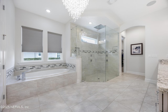 bathroom featuring separate shower and tub, tile patterned flooring, a notable chandelier, and vanity