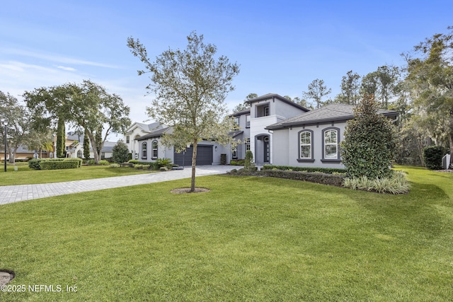 view of front of property featuring a garage and a front yard