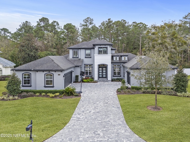 view of front of property with a garage and a front yard