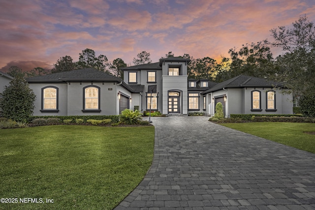 view of front of house with a lawn and a garage