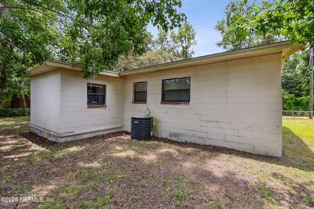 rear view of property featuring cooling unit