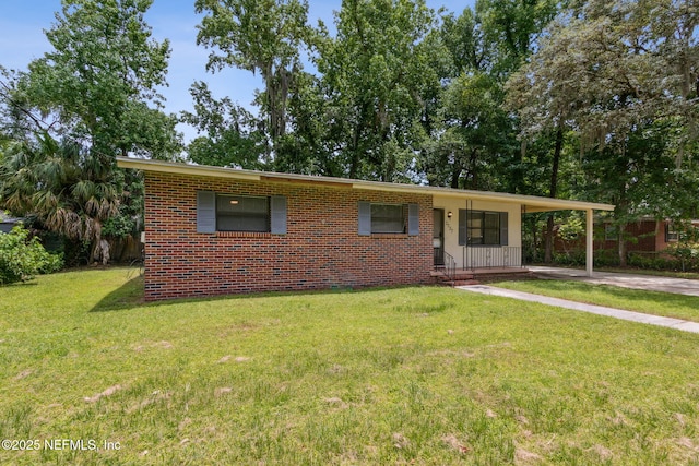 ranch-style home featuring a carport and a front lawn