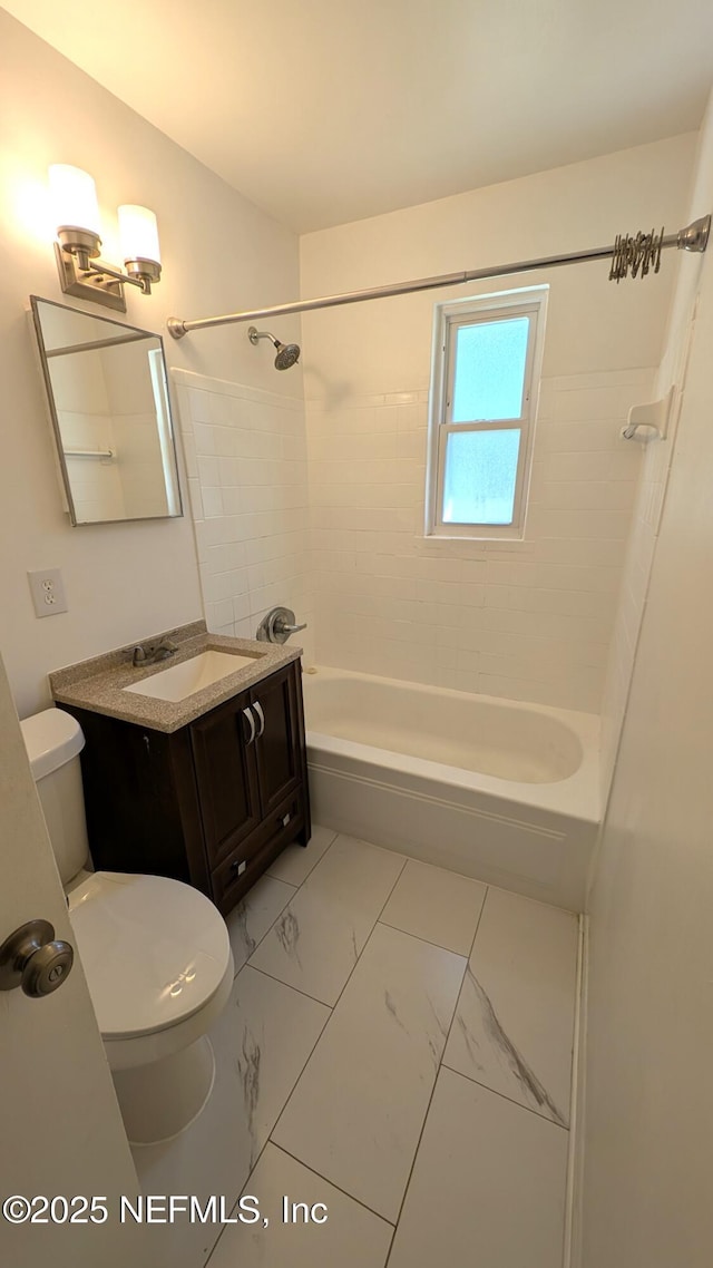 full bathroom featuring tiled shower / bath combo, toilet, and vanity