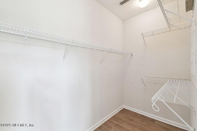 spacious closet featuring hardwood / wood-style flooring